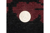 Scale detail of the hand-knotted full pile in burgundy and black on a vintage Indian carpet.