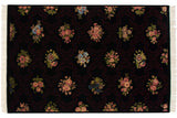Repeating pattern of floral blossoms within a subtle burgundy trellis on a black Indian carpet.