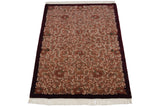 Terracotta and ivory Rococo vinery with carved contour and fringe on the rug corner.