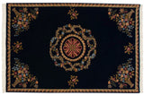 Vintage Indian Aubusson design carpet with a floral roundel medallion and corner bouquets on a dark blue field.