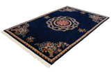 Angled view of a European-style Aubusson carpet with its roundel medallion and floral corner bouquets.