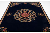 Angled view of a vintage Indian Aubusson carpet, highlighting the layout of floral motifs on its plush cobalt blue field.