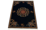 Aubusson style carpet with a floral medallion and corner bouquets on a deep cobalt blue field.