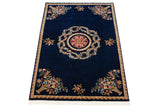 Angled view of a vintage Aubusson design rug highlighting its floral bouquets and medallion.