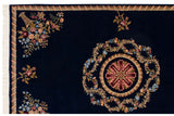 Carved roundel medallion and floral corner bouquet on a cobalt blue Aubusson design rug.