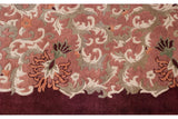 Rococo vinery with shallow carved contour on terracotta field and burgundy border.