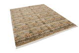 Indian abstract carpet with repeating primitive patterns in beige, olive, gold, and orange.