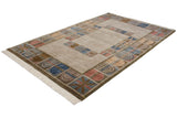 Indian abstract rug corner showing geometric multi-panels in beige, blue, red, and fringe.