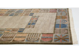 Close-up of vintage Indian carpet border with multi-panel abstract motifs and ivory fringe.