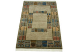 Ivory fringe and geometric abstract panels in denim blue, madder red on Indian rug corner.