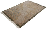 Fringed corner of Indian rug, slate blue carved foliage, beige texture, olive border.