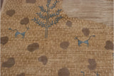 Shallow carved contour of beige folk art rug, slate blue animal, and pebbles.