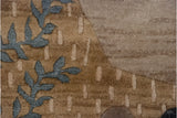 Close-up of the carved contour details: slate blue foliage on a textured beige ground.