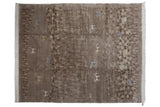 Textured folk art landscape rug with carved deer, blue antelope, and pinwheel spirals.