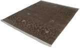 Indian Folk Art rug corner showing carved texture, pinwheel spirals, and ivory fringe.