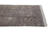 Shallow carved contour, pinwheel spirals, and ivory fringe on a vintage Indian rug.