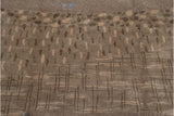 Woven shallow carved contour with abstract brown lines on Indian Folk Art carpet.