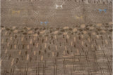 Shallow carved contour showing beige, brown, ivory pebbled design on folk art rug.
