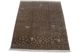 Textured brown and beige pebbled design with a shallow carved ivory and blue pinwheel.