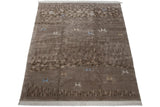 Sculpted beige and coffee brown rug with pebbled texture and antelope figures.
