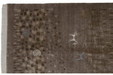 Fringed edge, shallow carved contour, and muted brown pebbled pattern with spirals.