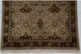 Intricate Arts and Crafts style border and ivory fringe of a vintage Indian rug.
