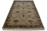 Vintage Indian William Morris rug corner: beige floral field, brown border, ivory fringe.