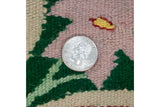 Close-up of hand-woven vintage Romanian kilim texture, floral pattern with coin.