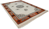 Tangerine orange border with silver fretwork and carved cloudband motifs on ivory Peking rug.