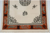 Vintage Peking carpet corner detail: shallow carved ivory, tangerine border, grey floral spandrel.
