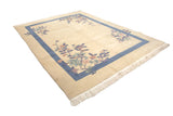 Art Deco rug with carved ivory field, pale blue border, and rose, mauve, jade florals.