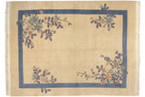 Fringe and carved floral motif in dusty rose, mauve, and jade green on a Chinese Art Deco carpet.