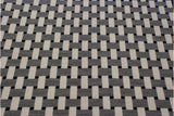 Close-up of the modern Soumac carpet's basketweave pattern in ivory, charcoal, and black.