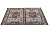 Angled view of Southwestern geometric Soumac carpet with wave and finned design motifs.