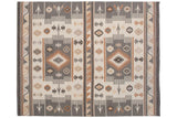 Southwestern Soumac carpet detail with charcoal, ivory, beige geometric motifs.
