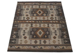 Southwestern Indian Soumac rug featuring geometric diamond, wave, and finned patterns in neutral tones.