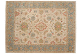 Indian Sultanabad design carpet with a floral medallion on an ivory field and a dusty slate blue border.