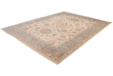 Angled view of the Sultanabad carpet's intricate floral field and wide, dusty slate blue border.
