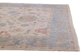 Angled view of a hand-knotted Indian carpet corner showing the intact side selvage and short pile.