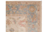 Corner view of an Indian Sultanabad carpet highlighting the intact side cord selvage and dusty blue floral border.