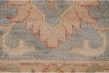 Short, even wool pile of a Sultanabad design carpet in dusty slate blue with blush and terracotta details.