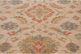 Detail of the Sultanabad design showing Herati scrolled leaves and florals in blush, slate blue, and green.