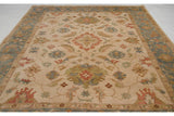 Indian Sultanabad design carpet seen from an angle, showing its ivory field and slate blue border.