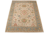 Floral border in dusty slate blue and wheat on the corner of a Sultanabad design rug.