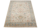 Indian Sultanabad carpet with a floral medallion on an ivory field and a dusty blue border.