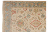 Dusty slate blue floral border and intact side cord on a hand-knotted Indian Sultanabad design carpet.