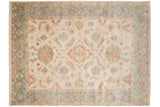 A hand-knotted Sultanabad carpet's floral pattern shown in ivory, slate blue, and terracotta.