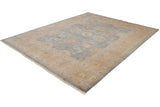 Indian Oushak carpet corner: dusty blue field, sand floral border, and pale blue selvage.