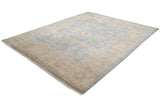 Corner of Indian Oushak design carpet with intact selvage and floral motifs in wheat and blue tones.