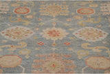 Pale slate silver blue field with wheat and cinnabar red floral palmettes and arabesques.